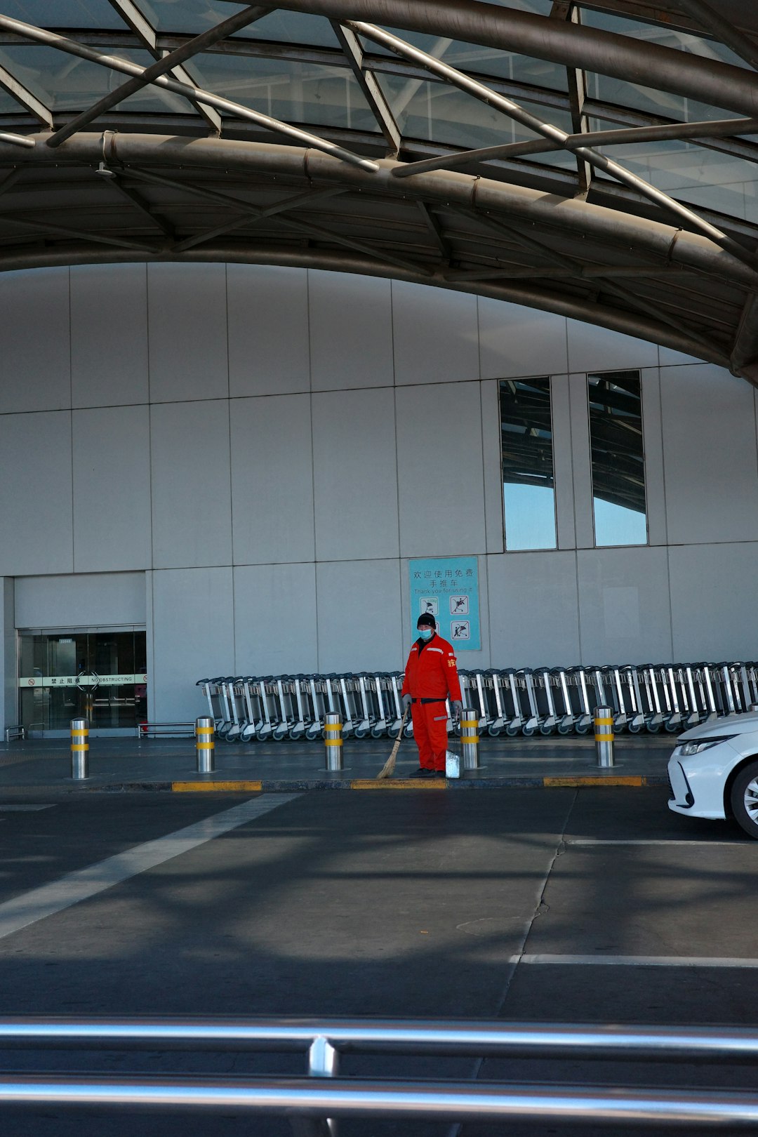a man cleaning at the airport pickup area